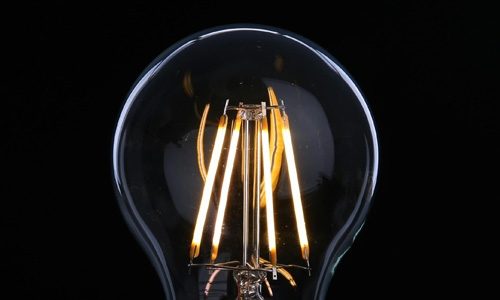 LED filament bulb close up on black background