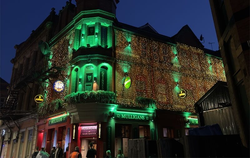 Green outdoor sign lights and colour changing floodlights at Mulligans Deansgate Manchester