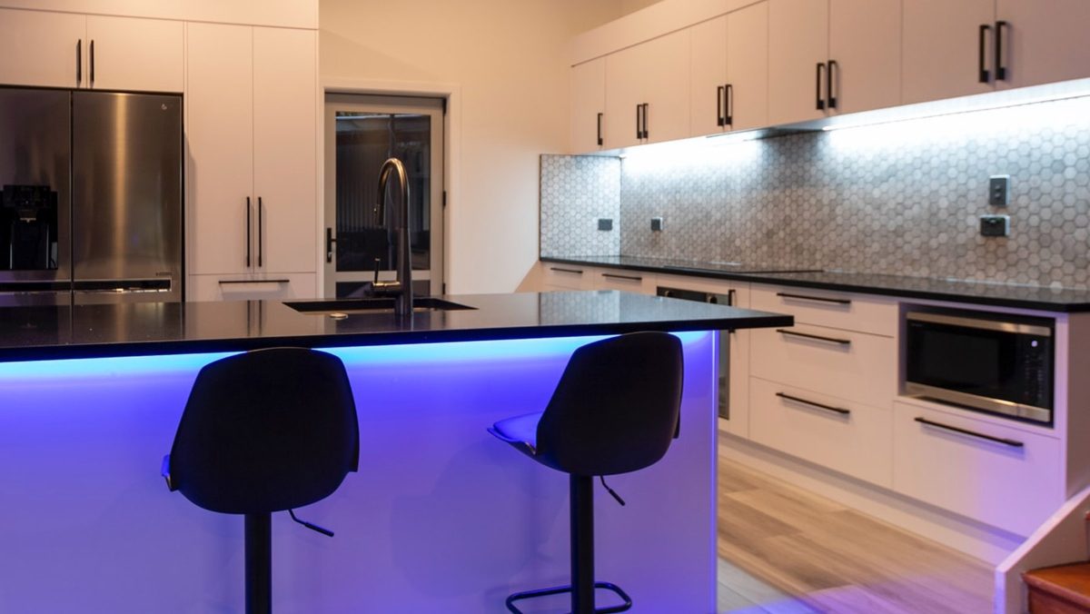 LED Strip Lights inside a kitchen with blue LED lights under a breakfast bar and white LED light under the kitchen cabinets