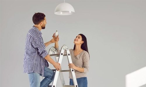 People Changing a Light Bulb Together