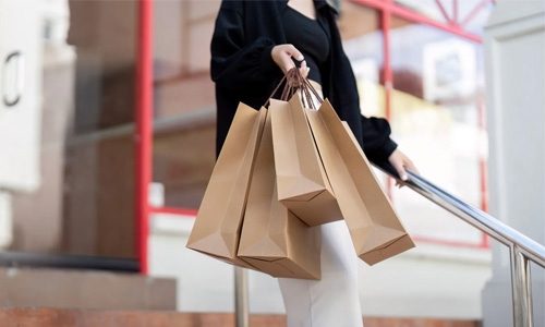 Person Leaving The Shop Carrying Their Bags